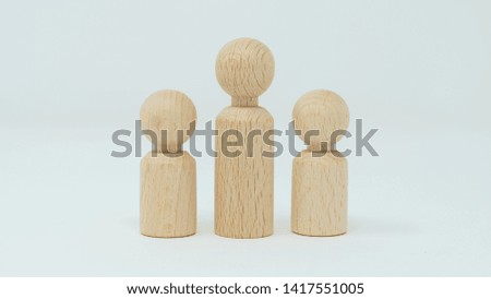 Abstract representation of a single parent family with children. 
Wood figures, white background. 