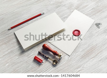 Vintage stationery and blank envelope on light wooden background. Template for graphic designers portfolios.