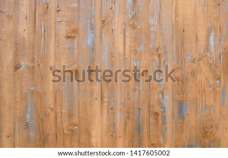 Natural wooden background. Surface of wooden texture for design and decoration. Shabby vertical boards with peeling paint. Brown and gray color. Copy space.