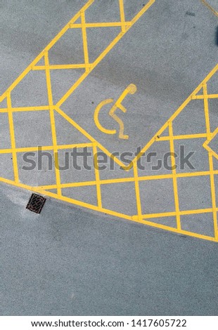 parking bay and disable parking bays from above photographed in an urban setting with a drone. lines and pattern street road markings. straight lines and geometric. street drone photography above