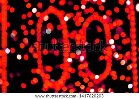Unfocused abstract red bokeh on black background. defocused and blurred many round light.