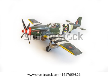 Scale model of the airplane fighter on a white background. Toy. Royalty-Free Stock Photo #1417659821