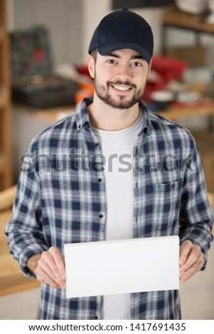 young engineer holding banner on white background