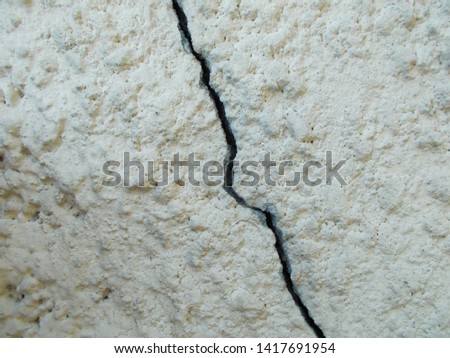 Cracks on the plastered wall of the house