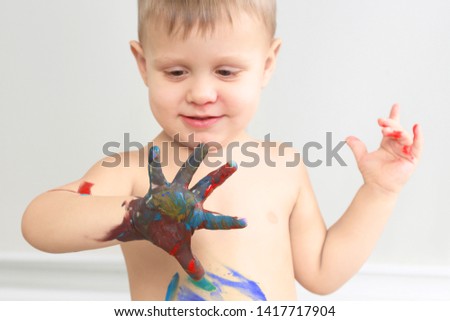 child paints with paint your hand. artistic creativity in children's development
