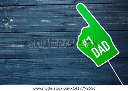 Decorations for Father's day on gray wooden background with copy space. Photobooth for Dad's holiday.
