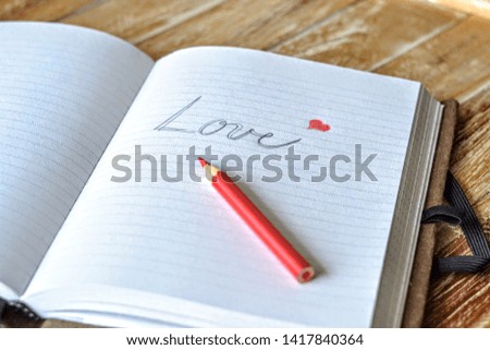 Love romantic message with red heart in scrapbook
