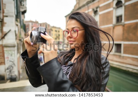 Travel photographer woman with camera in Venice, Italy. 