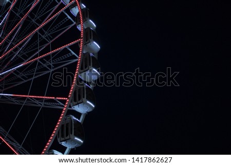 View of ferris wheel gondolas.