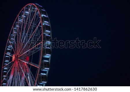 Ferris wheel on dark sky background.
