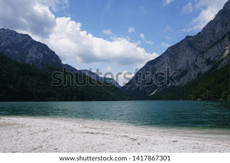 View from the shore of a pond to the mountains