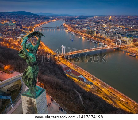 Budapest, Hungary - Aerial panoramic view of Budapest from above, with Statue of Liberty, Elisabeth and Szecheni Chain Bridge and sightseeing boat on River Danube at blue hour Royalty-Free Stock Photo #1417874198