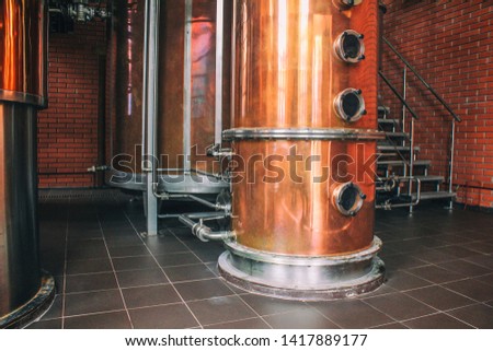 Industrial equipment for brandy production.
Copper still alembic inside distiller to distill grapes and produce spirits. Noises and large grain - stylization under the film. Soft focus