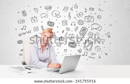 Beautiful young businesswoman with all kind of hand-drawn media icons in background