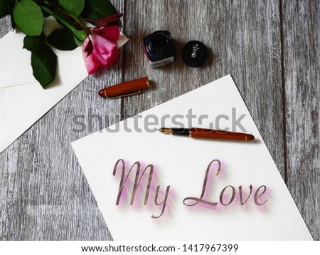 wooden with white sheet pen and flower, love massage, love latter, top view