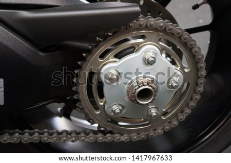 Detail of a new motorcycle rear chain and gear                               