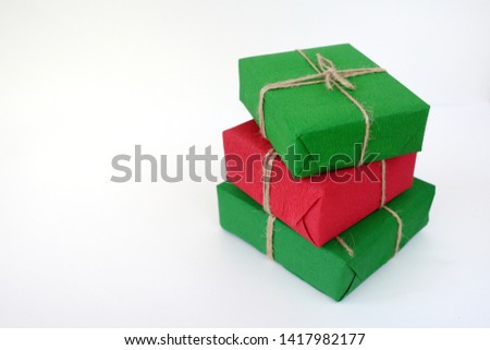 Christmas gifts in Kraft packaging on wooden background.