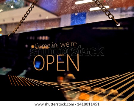 Close up image of shop's open card at the shop entrance.
