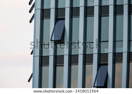 Abstract image of looking up at modern glass and concrete building. Architectural exterior detail of office building. - Image