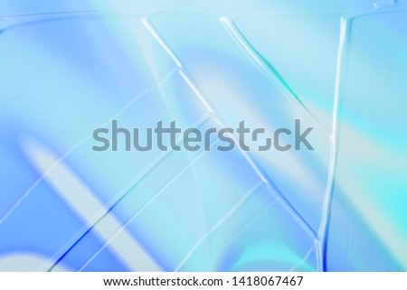 vaporwave style texture background: neon blue holographic funky paint wave texture. Close up, flat lay.