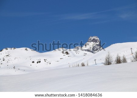 Alpine landscape with mountains and snow in a sunny day.