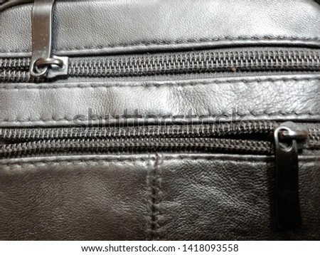 Metal zipper on the skin. Clasp close up.