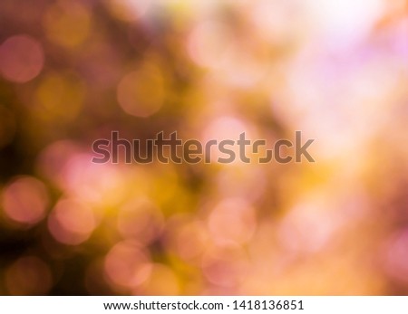 Summer abstract bokeh background in soft warm pastel orange and pink tones with sun rays. Beautiful bokeh summer sunlight background.