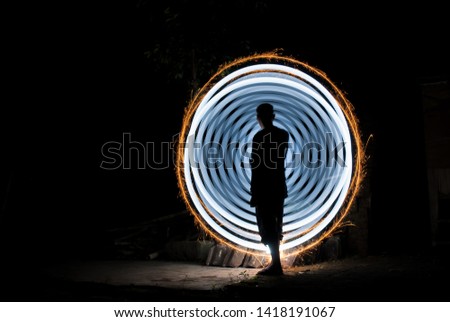 Indonesian people silhouettes on a white circle pattern as a backdrop isolated on dark background 