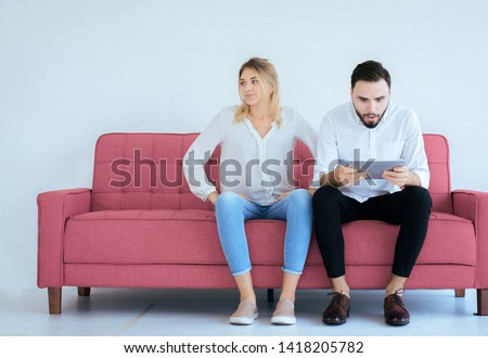 Bored and disregard couple lover sitting on couch at home together,Family issues Royalty-Free Stock Photo #1418205782