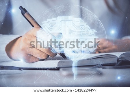 Double exposure of woman's writing hand on background with brain hologram. Concept of brainstorming.