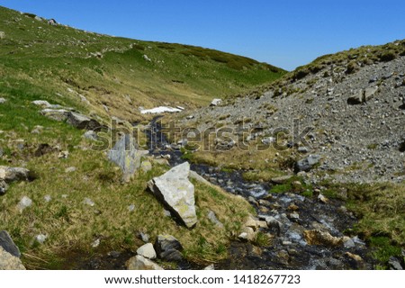 Hills with spring with blue background