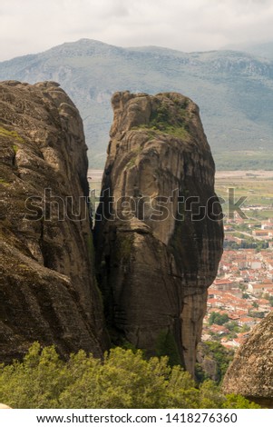 Beautiful scenic view of Kalambaka town and Thessaly valley with mountains and rocks in Meteora, Pindos Mountains, Thessaly, Greece
