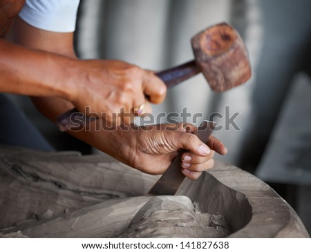 Hands woodcarver while working with the tools Royalty-Free Stock Photo #141827638
