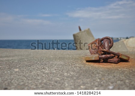 Rusty padlock on the breakwater in Poland.