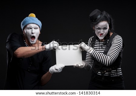 couple funny mimes holding sign