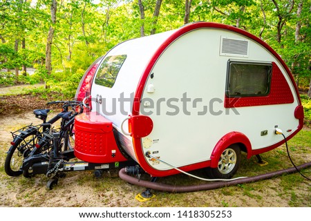 Red and White Teardrop Trailer with Bikes Royalty-Free Stock Photo #1418305253