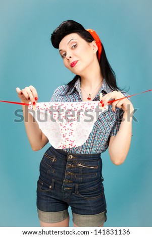 Beautiful pin-up style woman hanging her panties