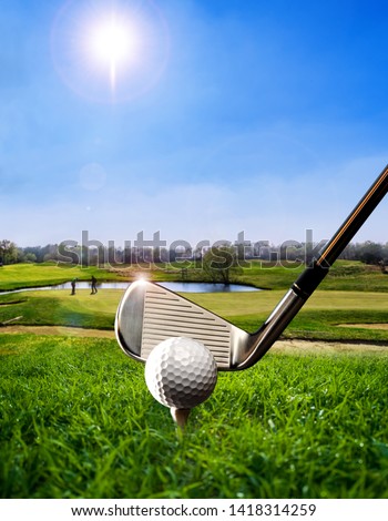 Golf ball on the tee at a golf course Royalty-Free Stock Photo #1418314259