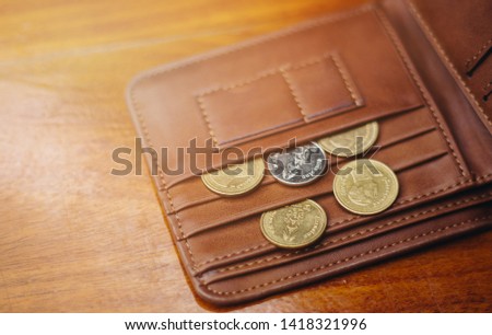 Metal bitcoins in brown leather wallet. Bitcoin - modern virtual.