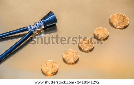 Stethoscope and gold coins on a golden background