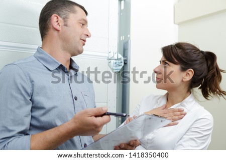 female customer talking about contract with plumber indoors