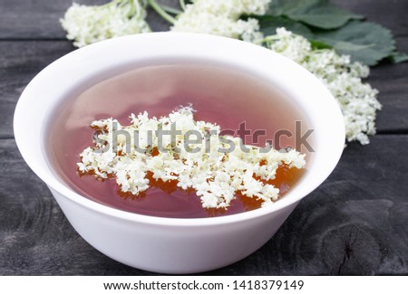 Elderberry tea with flowers on a wooden table. Healthy Medicine Elderberry Flower Tea
