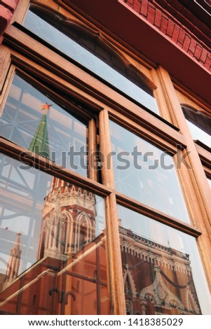 Trinity tower of Moscow Kremlin. Glass window reflection. Color photo.    