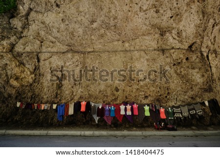 sale of traditional knitted wool products: clothes and shawls on the mountain road