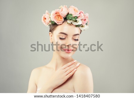 Young woman spa model portrait. Pretty girl with clear skin and flowers. Body care and skin care concept