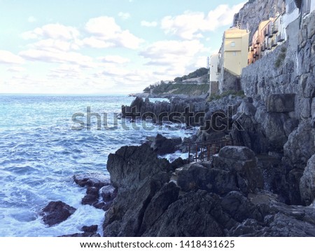 Colourful houses up on rocks above mediterranean sea at Cefalu in Sicily, Italy on a bright day Royalty-Free Stock Photo #1418431625