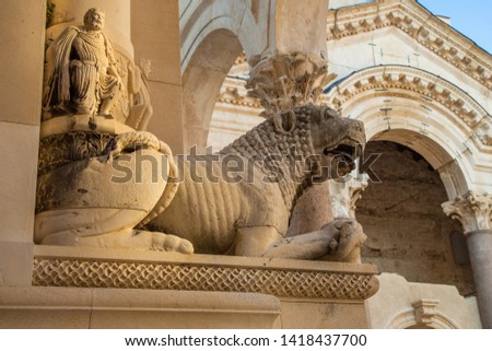 Split, Croatia, peristyle or peristil inside Diocletian Palace in the old town, statues of stone lions and arches from ancient Roman times Royalty-Free Stock Photo #1418437700