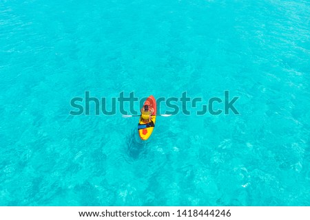 Kayak boat turquoise blue water sea, sunny day. Concept travel. Aerial top view.