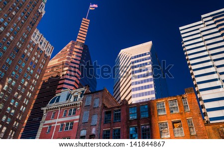 Looking up at a mix of modern and old buildings in Baltimore, Maryland.