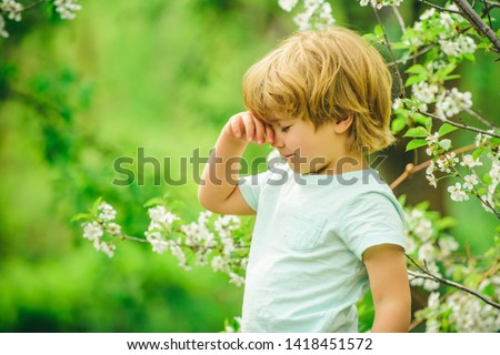 Child on the background of nature. Beautiful boy. Preschooler on green natural background. Kids in the garden. Calm and rest. Relaxation. Renewal. Put thoughts in order. Mental rest.